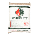 A bag of Woodlets wood pellets with the brand logo and product information displayed on the label.