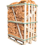 A pallet of kiln-dried hornbeam firewood logs contained within a transparent wrap, bound by metal bands.